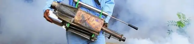 Fumigation technician using a fogger for deep pest treatment in Kansas City, KS
